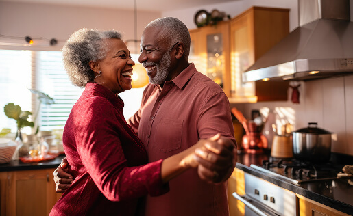 Couple joyfully dancing together in a cozy kitchen