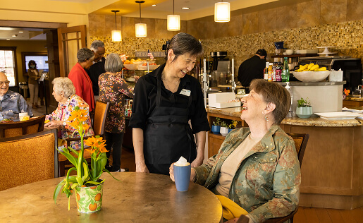 Waitress and customer smiling in a restaurant